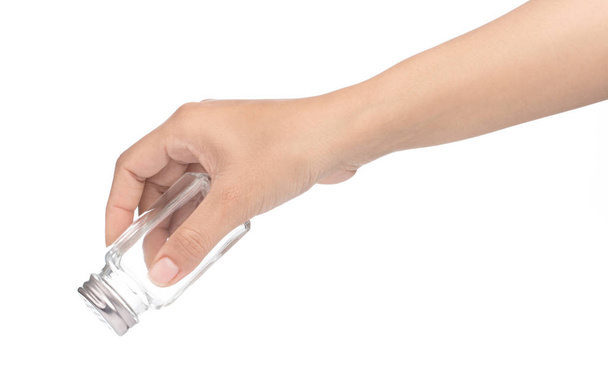 hand holding bottle glass for seasoning isolated on white backgr - Valokuva, kuva