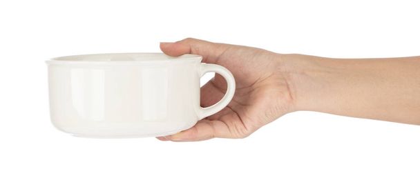 Χέρι κρατώντας άδειο λευκό σούπα Μπολ απομονωθεί λευκό φόντο - Φωτογραφία, εικόνα