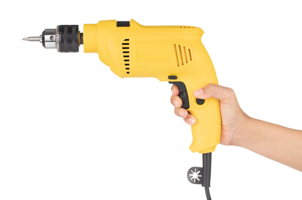 Hand holding Electric drill isolated on white background - 写真・画像