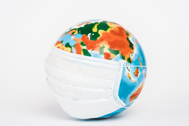 colorful globe in medical mask on white  - Photo, Image