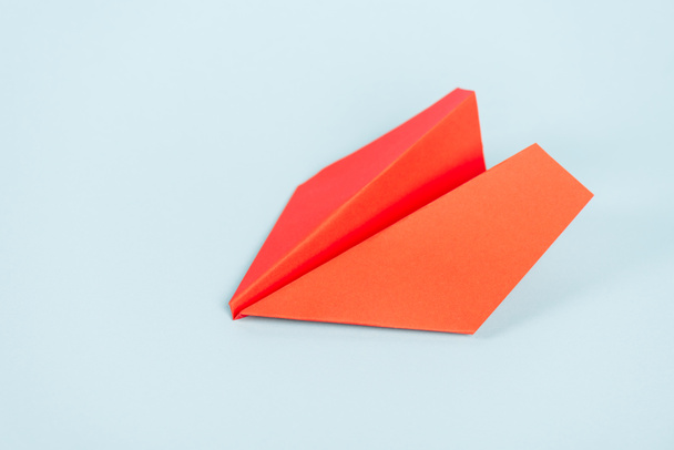 toy and orange paper plane on blue with copy space  - Φωτογραφία, εικόνα