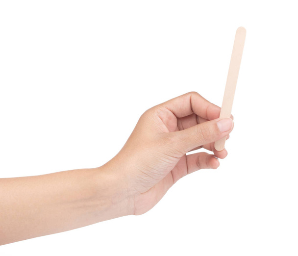 hand holding Wooden ice cream stick isolated on white background - 写真・画像