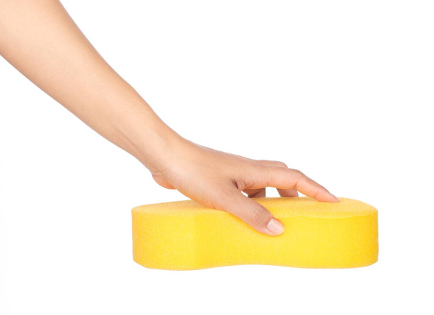 Hand holding yellow Sponge isolated on white background - Photo, Image