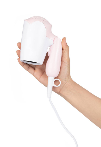 Hand holding Hair dryer color pink Isolated on White background - Fotó, kép