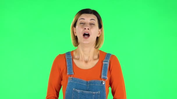 Girl got a cold, sore throat and head, cough on green screen at studio - Filmati, video
