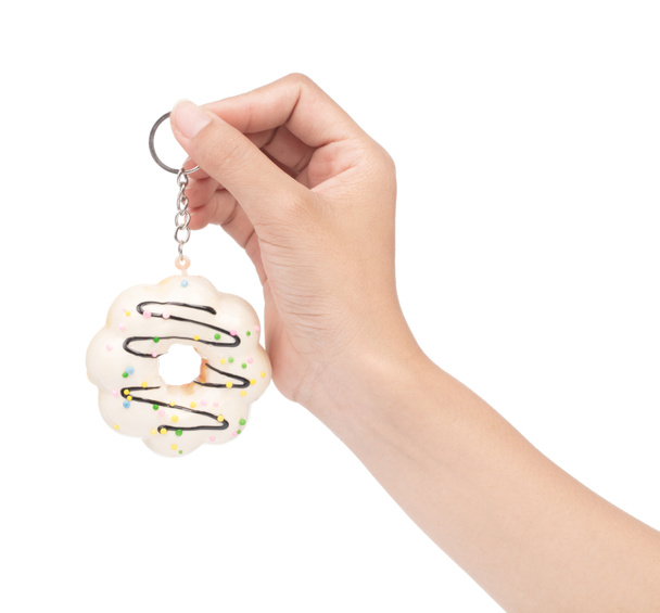hand holding key chain Donut isolated on white background. - Photo, Image