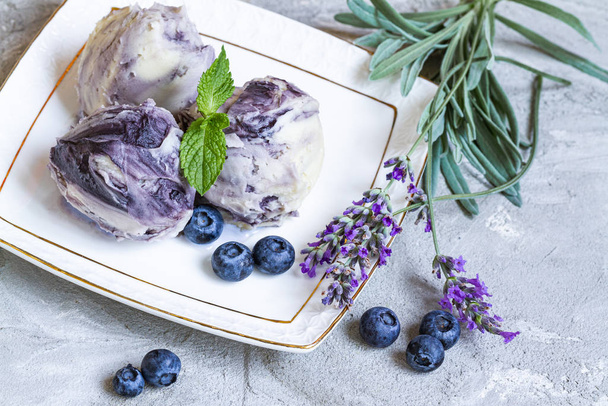 sweet cold dessert, classic lavender ice cream with blueberry syrup - Photo, Image