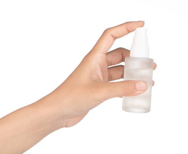 hand of a girl applied a cosmetic container bottle isolated on w - Photo, Image
