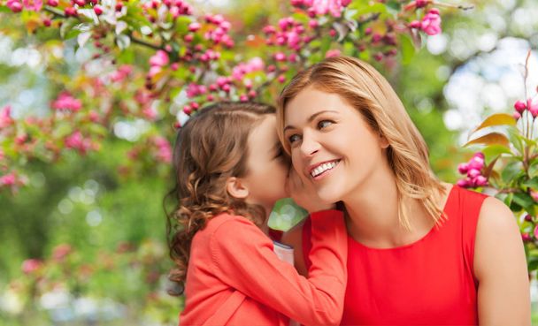 happy mother and daughter whispering her secret - Foto, Bild