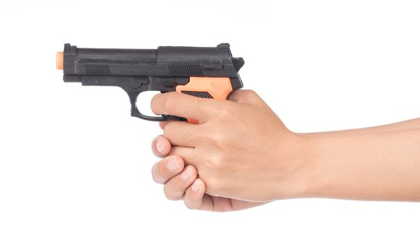 hand playing with a toy gun isolated on white background - Photo, Image