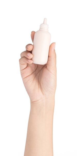 hand holding makeup liquid foundation isolated on white backgrou - 写真・画像
