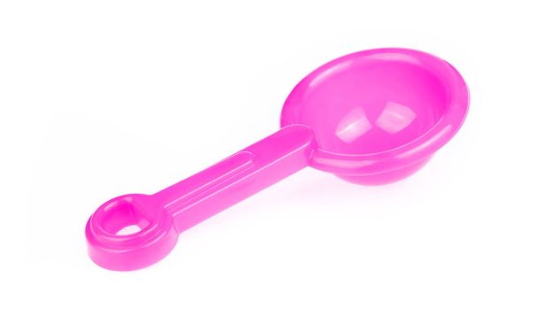 Hand holding Toy plastic pink of shovel isolated on a white back - 写真・画像