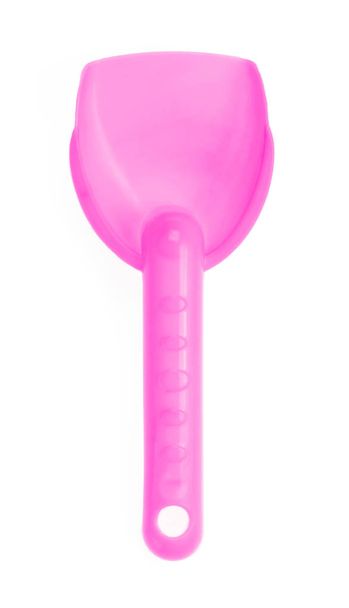 Small plastic toy shovel isolated on a white background. - Foto, imagen