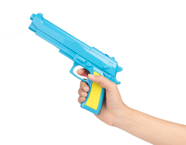 Hand holding Toy plastic gun for child isolated on a white backg - 写真・画像