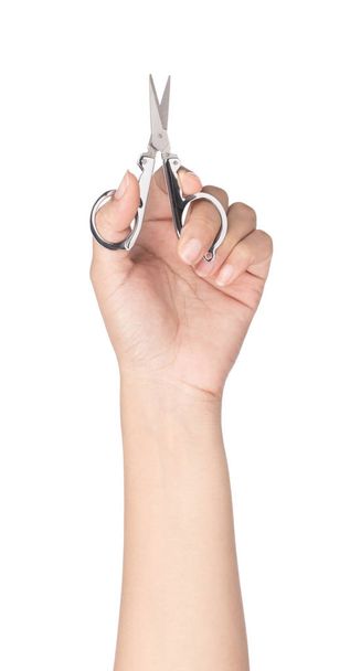 mão segurando tesoura de aço pequena isolada no fundo branco
 - Foto, Imagem