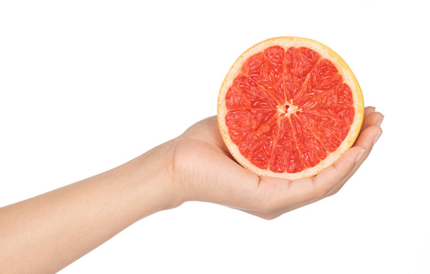 hand holding ripe grapefruit slice isolated on white background. - 写真・画像