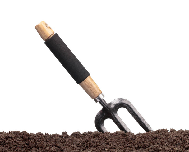 garden tools in soil isolated on white background - Foto, Imagem