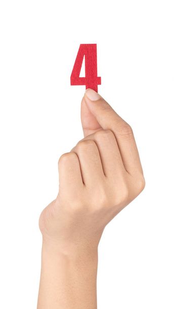 hand holding Number 4 made of felt isolated on white background - Φωτογραφία, εικόνα