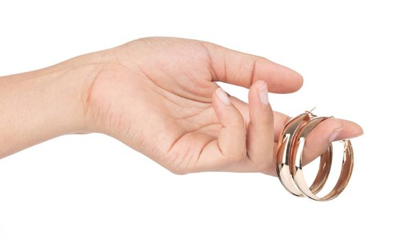 Hand holding Golden round earrings isolated on white background - Photo, Image