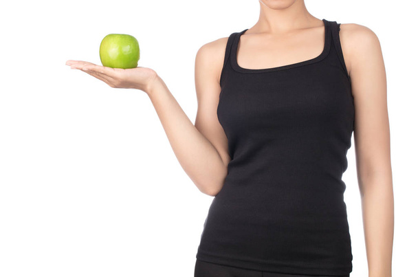 Young slim woman holding green apple. Isolated on white backgrou - 写真・画像