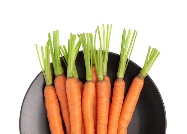 fresh baby carrots on dish isolated on white background - Photo, Image