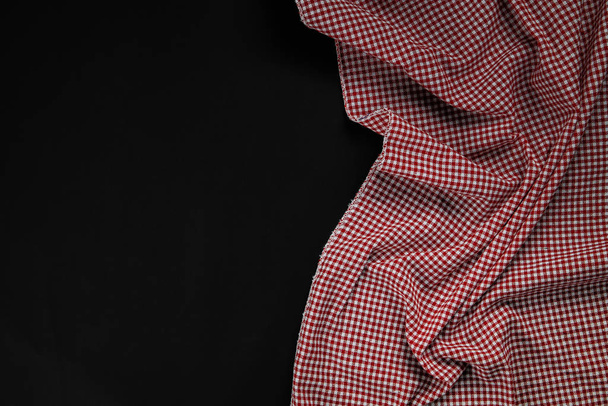 red checkered tablecloth on black background - Photo, Image