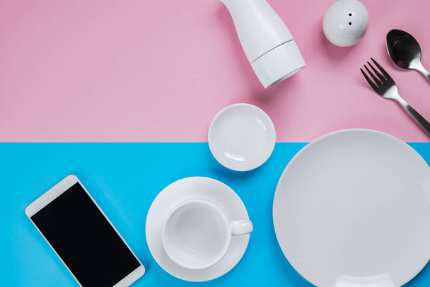 Collection of kitchenware with Smartphone on pink and blue backg - Fotoğraf, Görsel