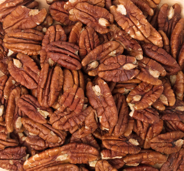 wood dish of pecan nuts isolated on white background - Photo, Image