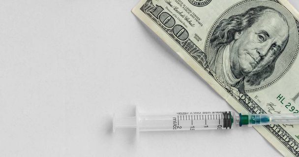 Money and syringe on gray background, vaccination concept, high cost of medical servicesy, flat lay - Photo, Image