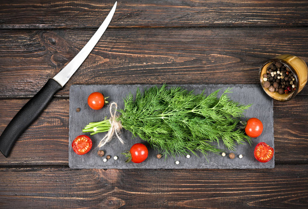bunch sprinkled with tomatoes on a wooden background - Photo, Image