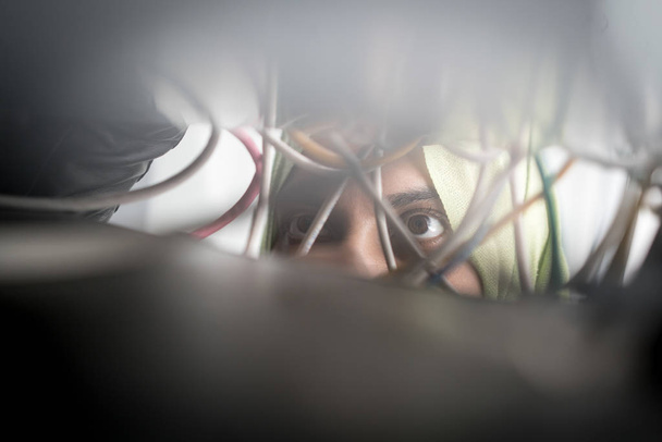 Muslim woman repairing cables in data center - 写真・画像