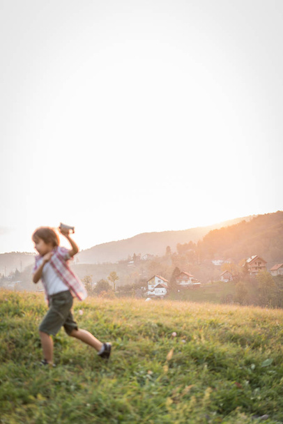 Little kid with kite on meadow - Φωτογραφία, εικόνα