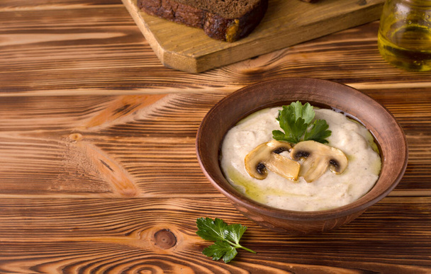 mushroom cream champignon soup traditional European dish on a wooden table. rustic style. copy space - Foto, afbeelding