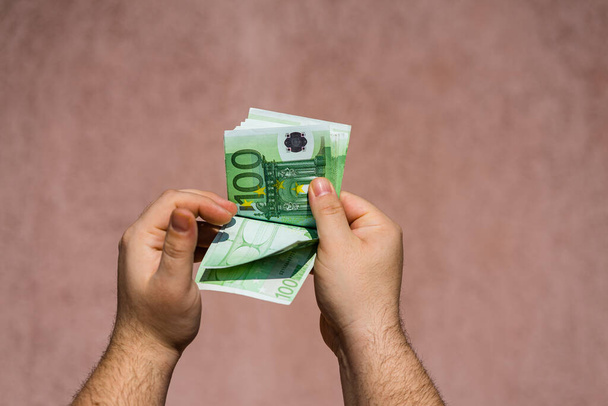 Hand couting holding and showing euro money or giving money. Wor - 写真・画像