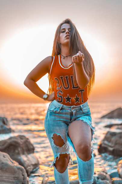  portrait of beautiful young woman at sea shore on sunset  - Foto, Imagem