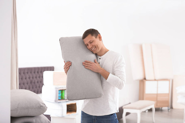 Happy man with cushion in mattress store - Foto, Imagem
