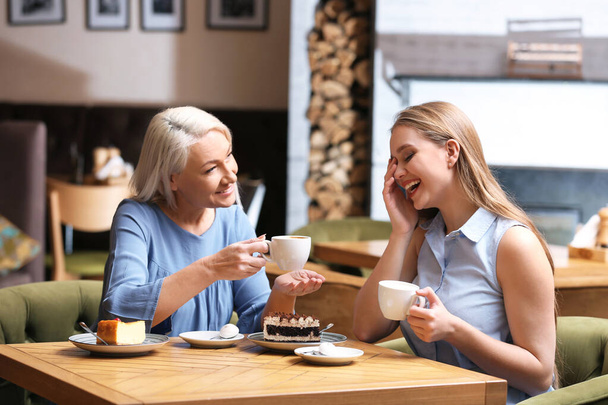 Mother and her adult daughter spending time together in cafe - Photo, image