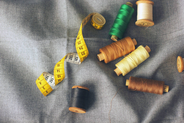 Sewing. Spools of thread on the fabric. Threads. Meter - Φωτογραφία, εικόνα