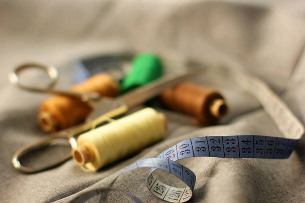 Sewing. Spools of thread on the fabric. Threads. Meter and scissors - Zdjęcie, obraz