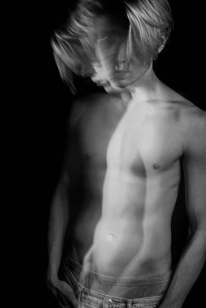 Dreamy artistic long exposure portrait of sporty man with naked torso. looking judging. emotions and anxiety. psychological concept photo. Black and white series of creative works - Фото, изображение