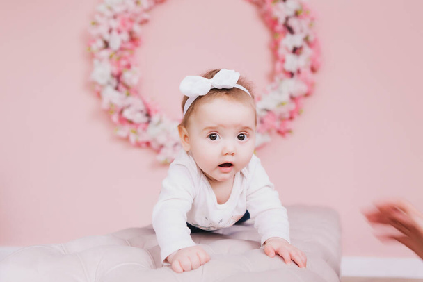 Image of sweet adorable baby girl with pink flowers - Фото, изображение