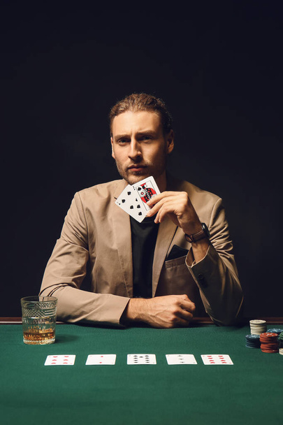 Young man playing in casino - Fotó, kép