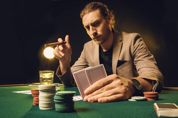 Young man playing in casino - Photo, Image