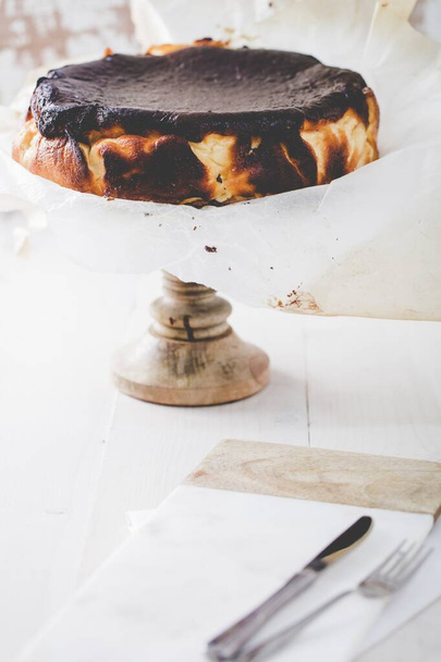 A beautiful shot of a cake with chocolate icing on a stand - Fotó, kép