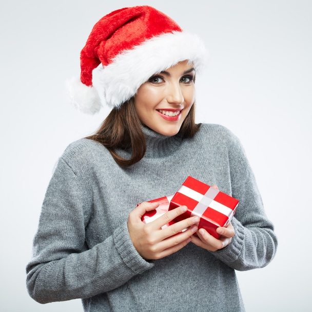 Portrait of woman in santa hat holding gift boxes - Foto, afbeelding