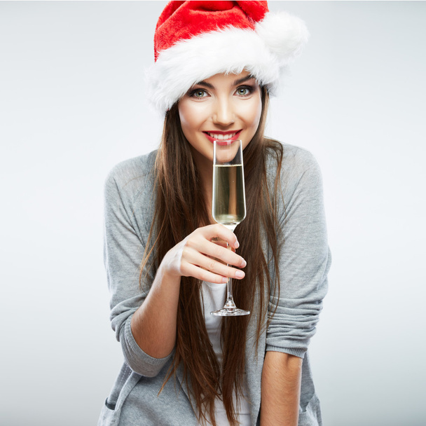 Woman in santa hat holding glass of champagne - Foto, Imagen