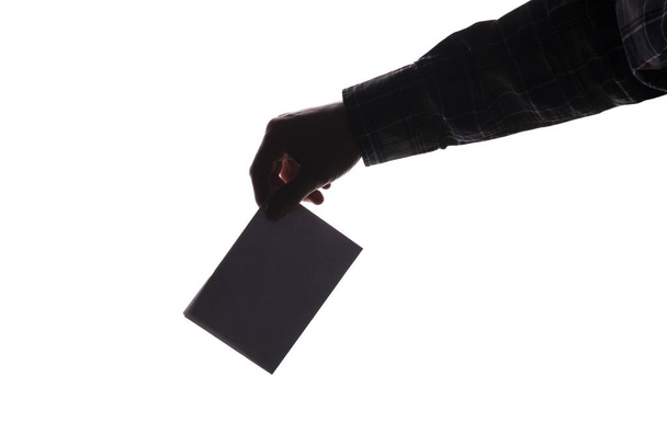 Silhouette of voter putting ballot into voting box. isolated background with copy-space - Foto, Imagem