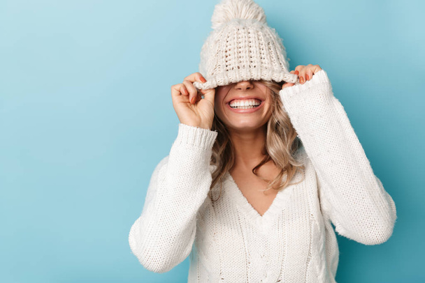 Portrait of nice cheerful woman laughing and making fun with her hat - Photo, image