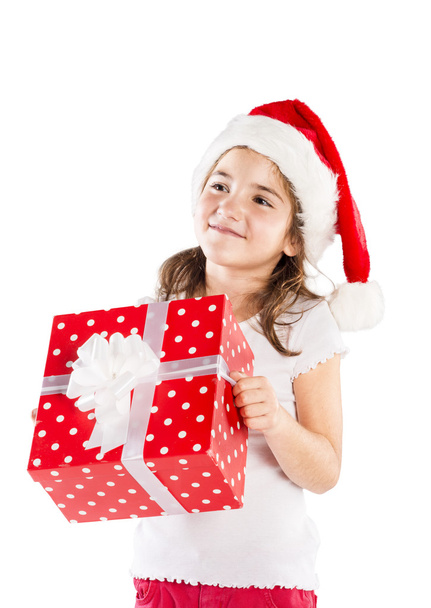 Small girl in santa hat with christmas gift - Fotografie, Obrázek