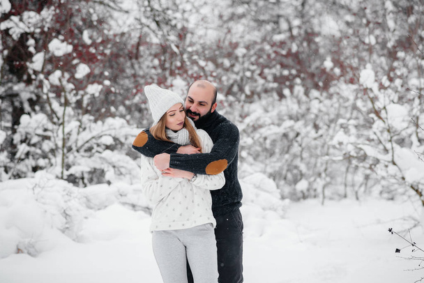 Couple playing with snow in the forest - Фото, изображение